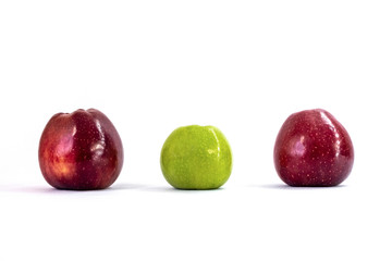 One green apple and two red apples on a white background. Organic fruit. Healthy lifestyle. Sweet fruit. Natural vegetarian healthy food. White background.