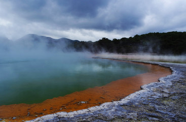 Geothermal lake with an orange shoreline