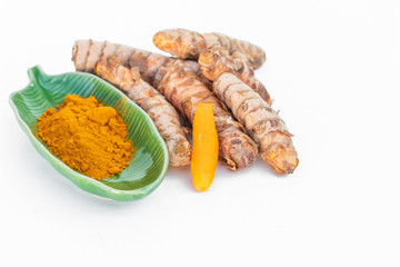 close up of curcuma in yellow roots and powder an ingredient for cuisine  antioxidant also for cosmetic, isolated on white background with copy space.