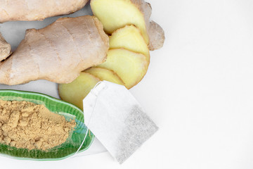 close up of ginger root, slices, in tea bag also with powder isolated on white background.