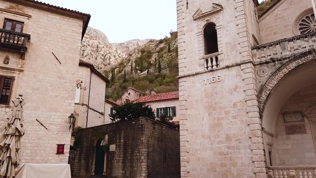 Cathedral of Saint Tryphon Square in old town of Kotor in handheld motion shot to the left. The oldest Cathedral in Montonegro (Yugoslavia)