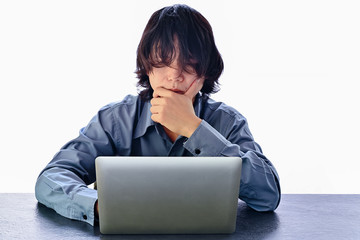 Business man with long hair covering his face using laptop table sitting on desk table and feeling thinking fatigue and headache. Stress and frustration concept