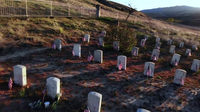 Headstones And American Flags At The Graveyard Of Fort Boise Military Cemetery In Boise, Idaho - drone shot