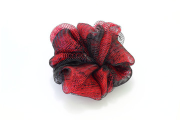 Sponge for washing the body of nylon threads in red and black on a white background. Washcloth...