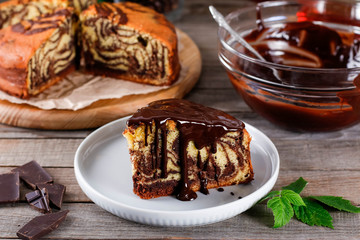Delicious piece of marble cake with chocolate on a plate