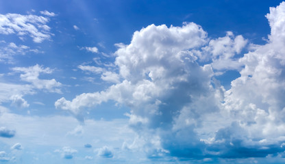 Naklejka na ściany i meble fluffy clouds with sunshine light in blue sky