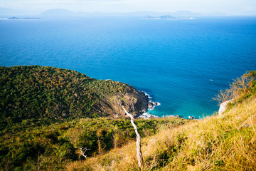 The blue sea, the hills covered with greenery in the background. Panoramic view of the sea landscape