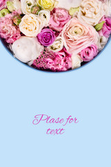 Greeting horizontal picture. Blue background with hat box and flowers. Vertical flatlay picture.