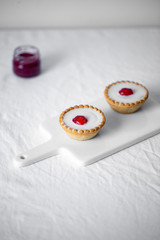 Vegan coconut Raspberry tartlets on white background