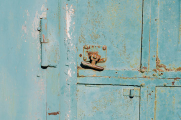 Vintage handle on the door. Steel door. Old, cracked paint.