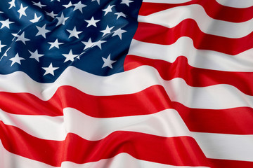 Close up of ruffled American flag. Satin texture curved flag of USA. Memorial Day or 4th of July. Banner, freedom concept