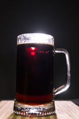 Glass beer on wood background with copyspace