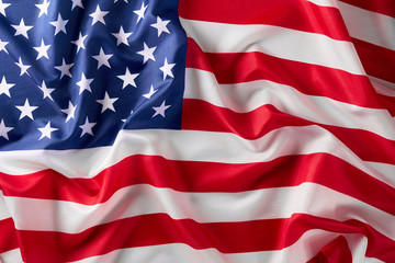 Fototapeta premium Close up of ruffled American flag. Satin texture curved flag of USA. Memorial Day or 4th of July. Banner, freedom concept