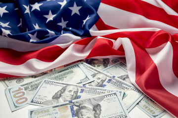 Fototapeta na wymiar Close up of american flag and dollar cash money. Dollar banknote and United States flag background. Economy of USA
