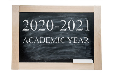 School blackBoard in a wooden frame and chalk with the text academic year 2020 2021. Isolated on white background.