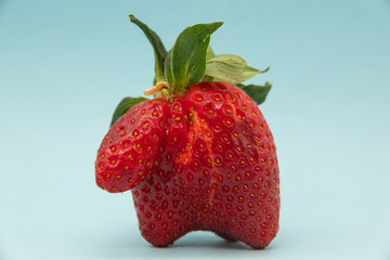 fresh strawberries strange shape mutant. Funny red fruit