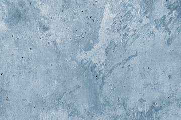 Old concrete wall tinted in light blue.