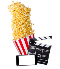 Flying popcorn, film clapper board and phone isolated on white background