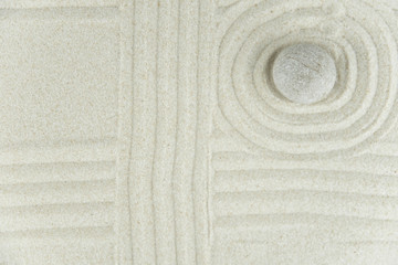 Zen garden. Pyramids of white and gray zen stones on the white sand with abstract wave drawings. Concept of harmony, balance and meditation, spa, massage, relax.