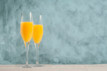 Two glasses of mimosa cocktail - obrazy, fototapety, plakaty