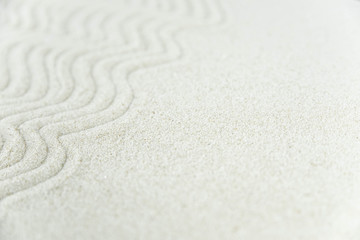 Abstract Zen drawing on white sand. Concept of harmony, balance and meditation, spa, massage, relax. Zen garden.