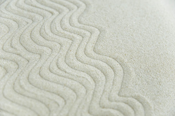Abstract Zen drawing on white sand. Concept of harmony, balance and meditation, spa, massage, relax. Zen garden.