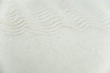 Abstract Zen drawing on white sand. Concept of harmony, balance and meditation, spa, massage, relax. Zen garden.