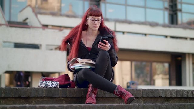 Young woman caught playing with phone when she should be studying - in slow motion