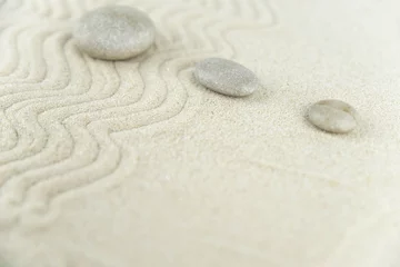 Fotobehang Zen Stenen Zen garden. Pyramids of white and gray zen stones on the white sand with abstract wave drawings. Concept of harmony, balance and meditation, spa, massage, relax.  © strigana