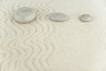 Fotobehang Zen Stenen Zen garden. Pyramids of white and gray zen stones on the white sand with abstract wave drawings. Concept of harmony, balance and meditation, spa, massage, relax.  © strigana