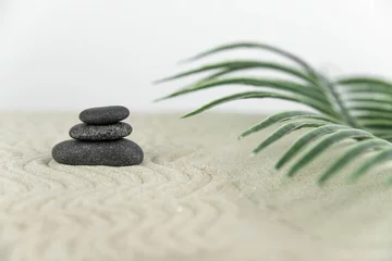 Fotobehang Zen Stenen Zen garden. Pyramids of white and gray zen stones on the white sand with abstract wave drawings. Concept of harmony, balance and meditation, spa, massage, relax.  © strigana
