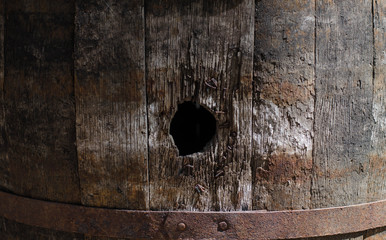 Old wooden barrel. Old boards. Tree structure. Iron hoops on a barrel.