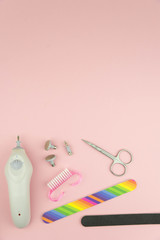 Product set of manicure and pedicure tools on trendy pink background. 
Hardware manicure set. Professional instruments for nail care. Beauty concept theme.
