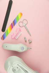 Product set of manicure and pedicure tools on trendy pink background. 
Hardware manicure set. Professional instruments for nail care. Beauty concept theme.
