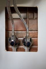 water faucets under the sink,connecting hot and cold water hoses for washing the kitchen under the...