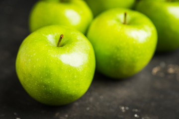 Close-up green apples on the rustic wooden background