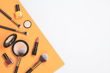Beauty cosmetic makeup set. Fashion woman make up product, brushes, lipstick, nail polish collection. Creative orange concept. Cosmetology make-up accessories banner, top view.