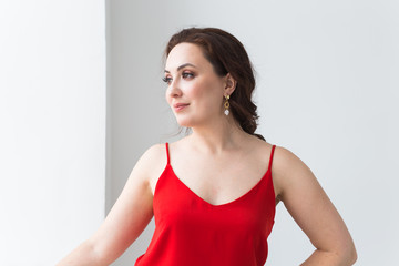 Close-up portrait of beautiful young woman with elegant hairstyle and luxurious jewelry and bijouterie.
