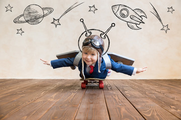 Portrait of young businessman with toy paper wings