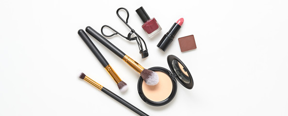 Beauty cosmetic makeup background. Fashion woman make up product, brushes, lipstick, nail polish layout. Creative concept. Cosmetology make-up accessories on white, banner, top view.