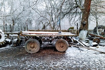 Old cart on farm yard at winter