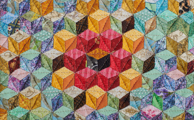 Fragment of quilt sewn from diamonds and has view three-dimensional