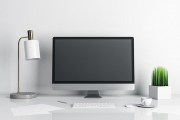 Stylish designer desktop with empty computer screen and lamp on table.