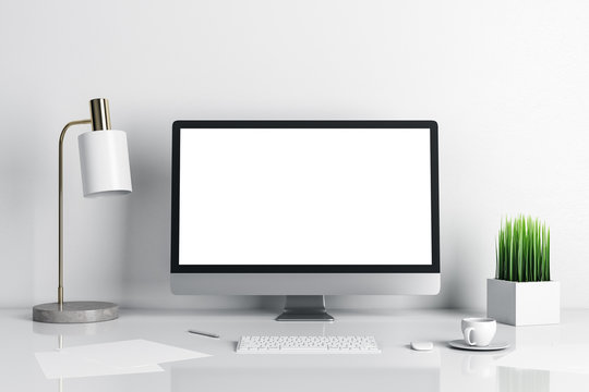 Contemporary designer desktop with empty computer screen