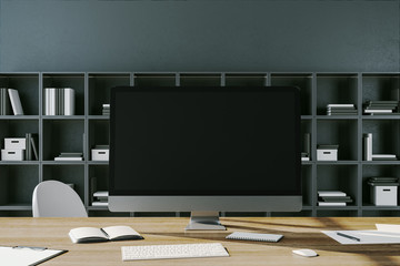 Modern workplace desktop with empty black computer screen