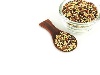 Organic tri-color Quinoa in wooden spoon with bowl isolated on a white background. High fiber, Superfood..