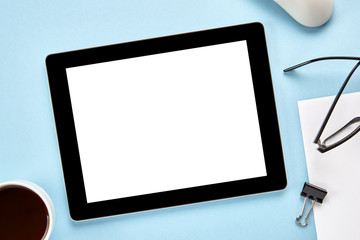 Mockup image of a tablet computer with blank white screen on blue surface. Flat lay