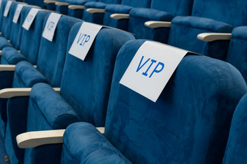 Row of empty chairs before business meeting.