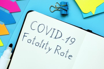 Conceptual photo about covid fatality rate with handwritten phrase.