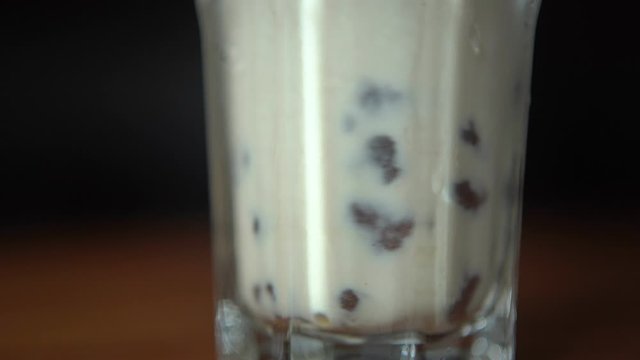 Stirring the Bobas at the bottom of the Bubble Tea drink